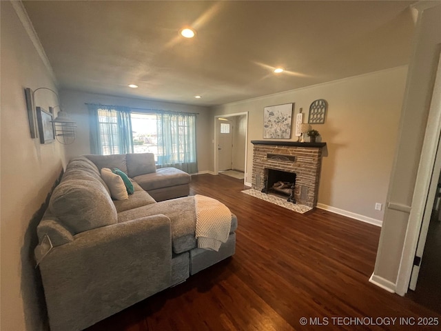 living room featuring crown molding, a fireplace, and dark hardwood / wood-style flooring