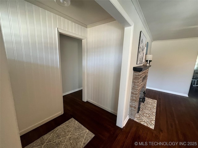 corridor featuring crown molding and dark hardwood / wood-style flooring