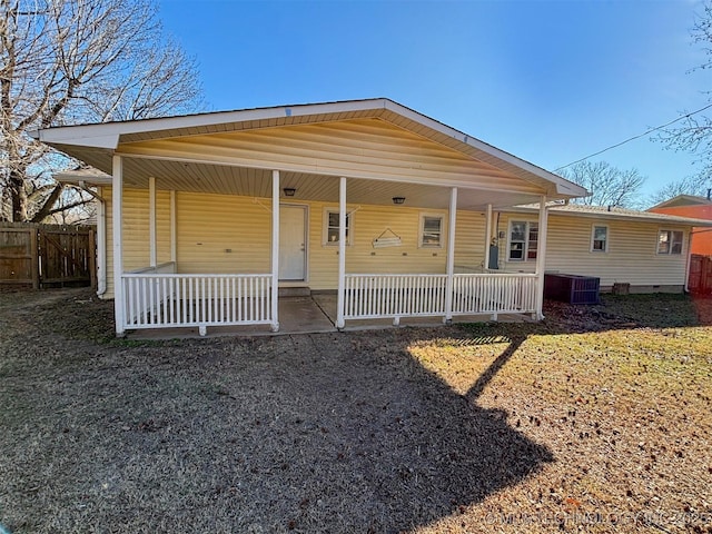 view of front of property featuring cooling unit and covered porch