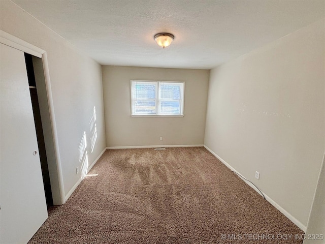 unfurnished bedroom with carpet and a textured ceiling