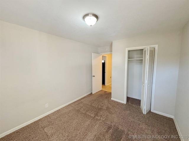 unfurnished bedroom featuring carpet floors and a closet