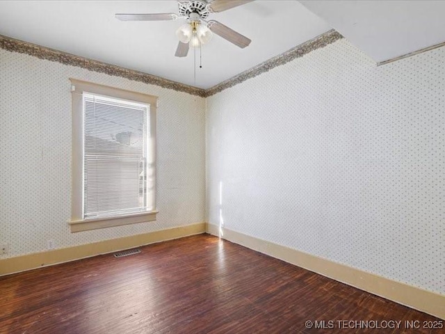 unfurnished room featuring dark hardwood / wood-style flooring, crown molding, and ceiling fan