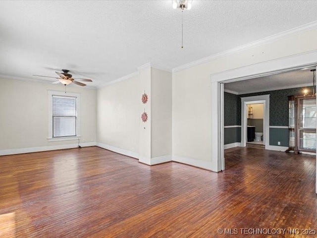 empty room with ornamental molding, dark hardwood / wood-style floors, and ceiling fan