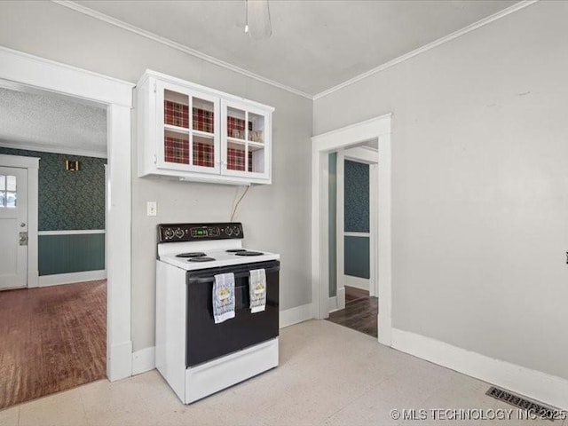 kitchen featuring white cabinetry, ornamental molding, and electric range