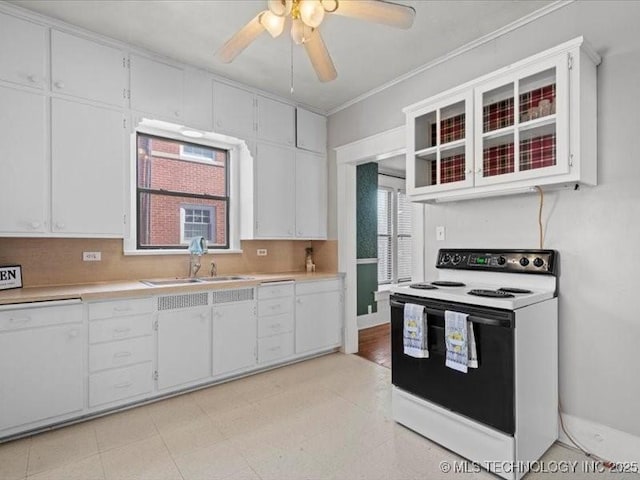 kitchen with sink, range with electric stovetop, ornamental molding, decorative backsplash, and white cabinets