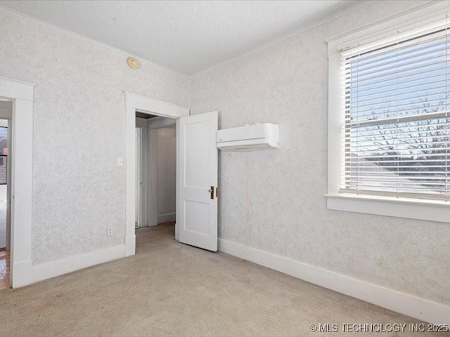 unfurnished bedroom with light carpet, crown molding, and an AC wall unit