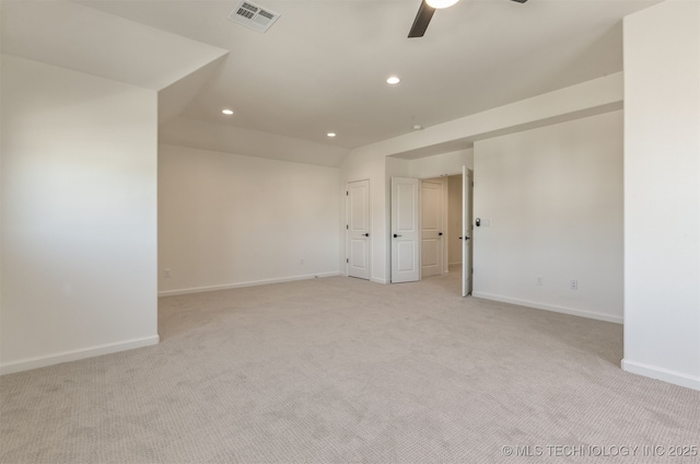 carpeted spare room with vaulted ceiling and ceiling fan