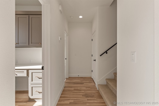 hallway with light hardwood / wood-style floors