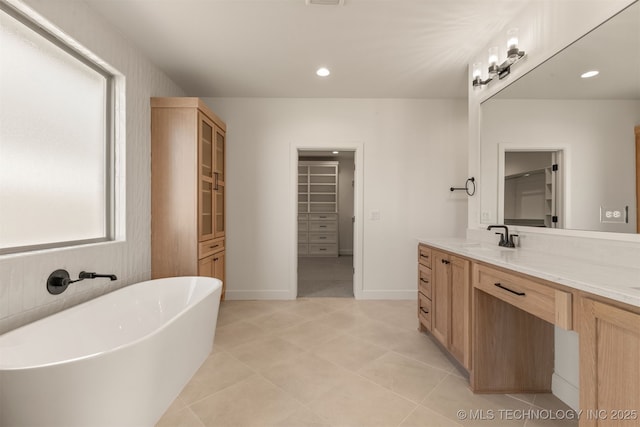 bathroom with a bathing tub and vanity