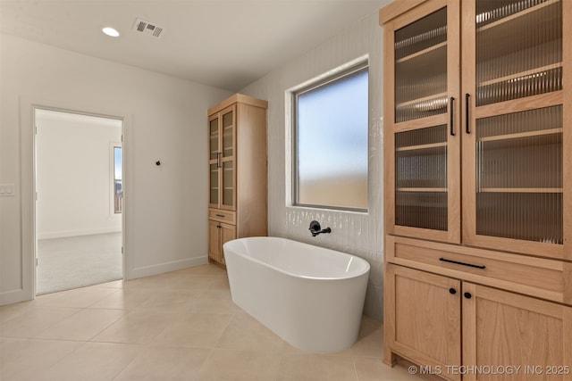 bathroom featuring tile patterned flooring and a bathtub