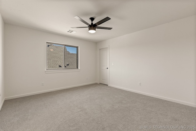 carpeted empty room featuring ceiling fan