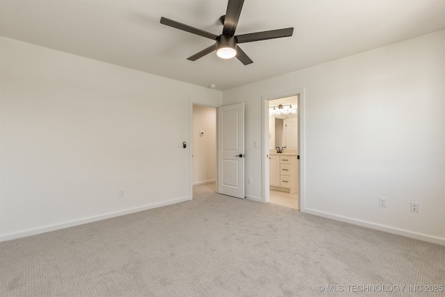 unfurnished bedroom featuring ceiling fan, ensuite bathroom, and light carpet