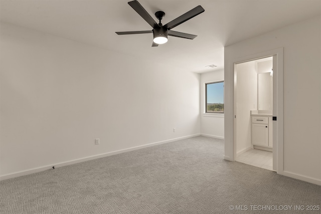 empty room with ceiling fan and light colored carpet