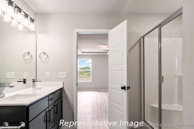 bathroom with vanity, hardwood / wood-style floors, and walk in shower