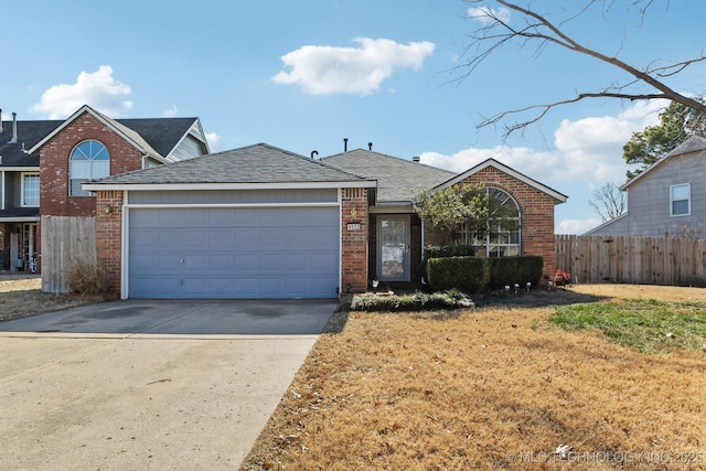 view of front of property with a garage and a front yard