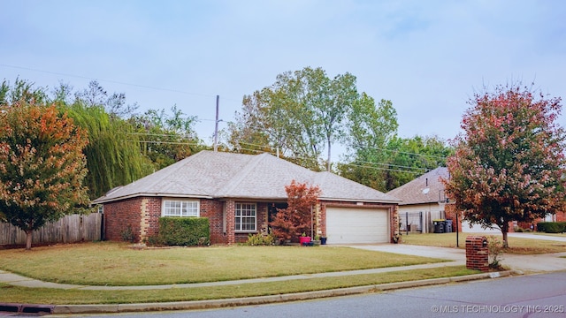 single story home featuring a garage and a front lawn