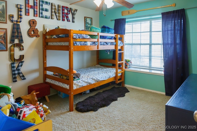 bedroom with ceiling fan, carpet floors, and multiple windows