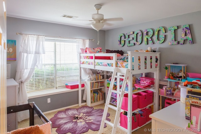 bedroom featuring ceiling fan, carpet floors, and multiple windows