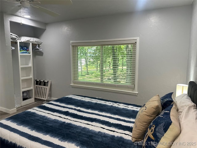 bedroom featuring wood-type flooring and ceiling fan