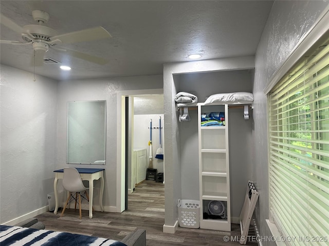 interior space with wood-type flooring and ceiling fan