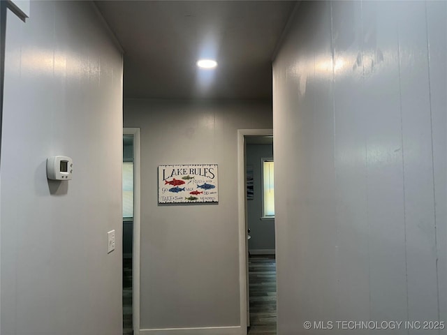 hallway with hardwood / wood-style flooring