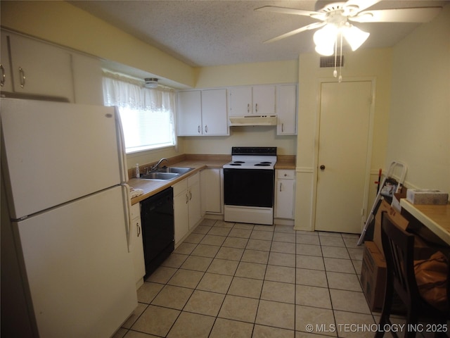 kitchen featuring sink, white cabinets, light tile patterned floors, white appliances, and a textured ceiling