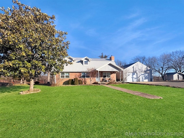 rear view of property with a garage and a yard