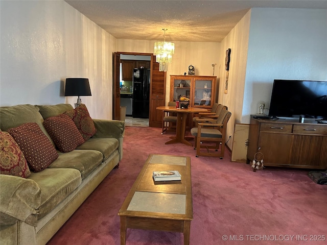 living room featuring a textured ceiling, a chandelier, and dark colored carpet