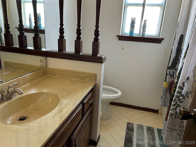 bathroom featuring vanity and toilet