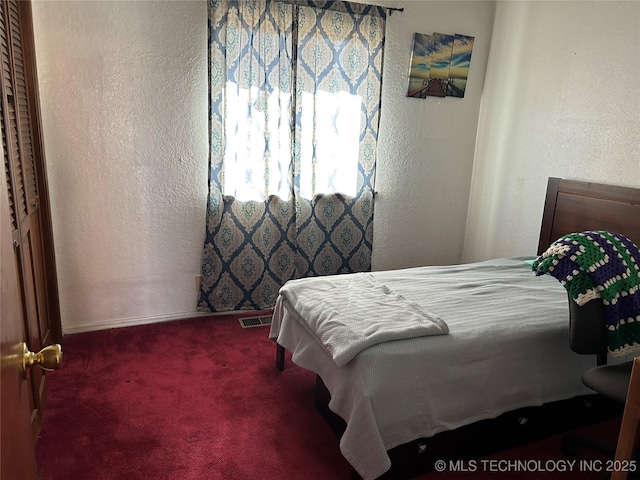 carpeted bedroom with a closet