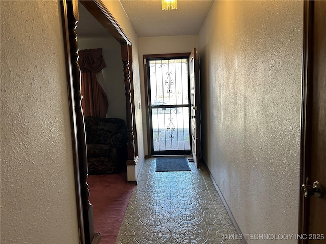 entryway featuring a textured ceiling