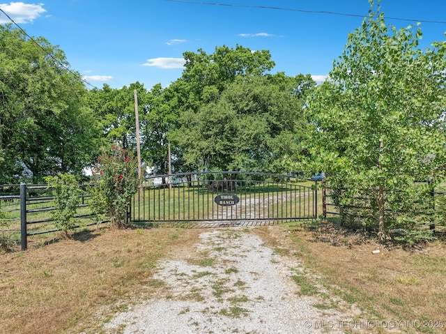 view of gate with a lawn