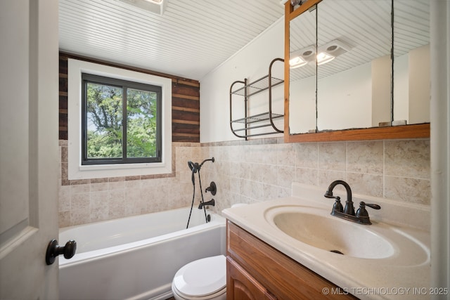 bathroom with vanity, toilet, and a bathing tub