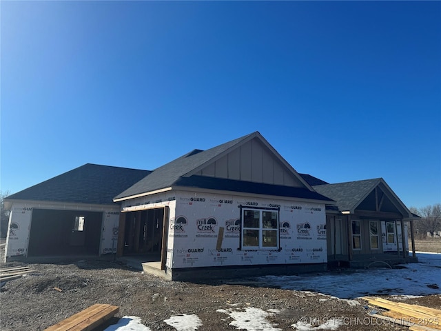 unfinished property featuring a garage