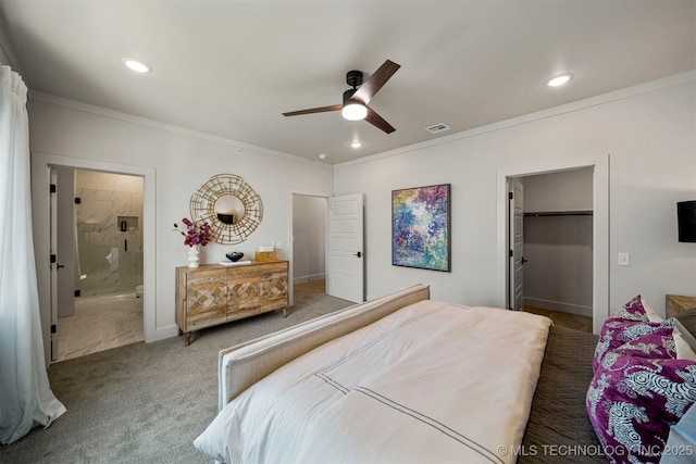 bedroom featuring a walk in closet, carpet floors, ornamental molding, and ceiling fan