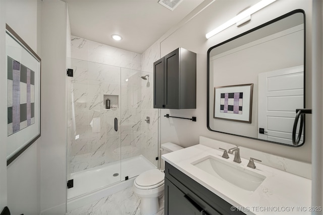 bathroom featuring an enclosed shower, vanity, and toilet