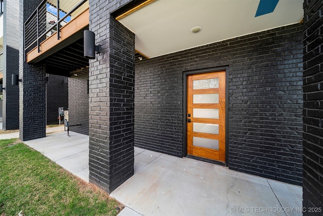 entrance to property featuring a patio