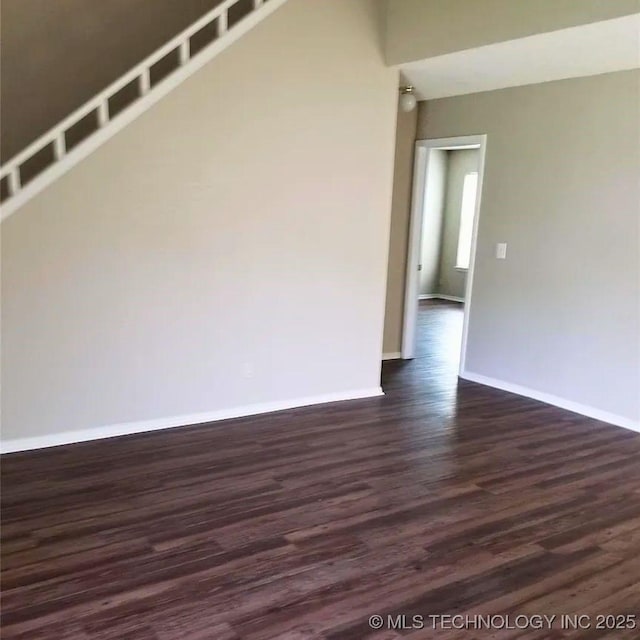 spare room with dark hardwood / wood-style flooring