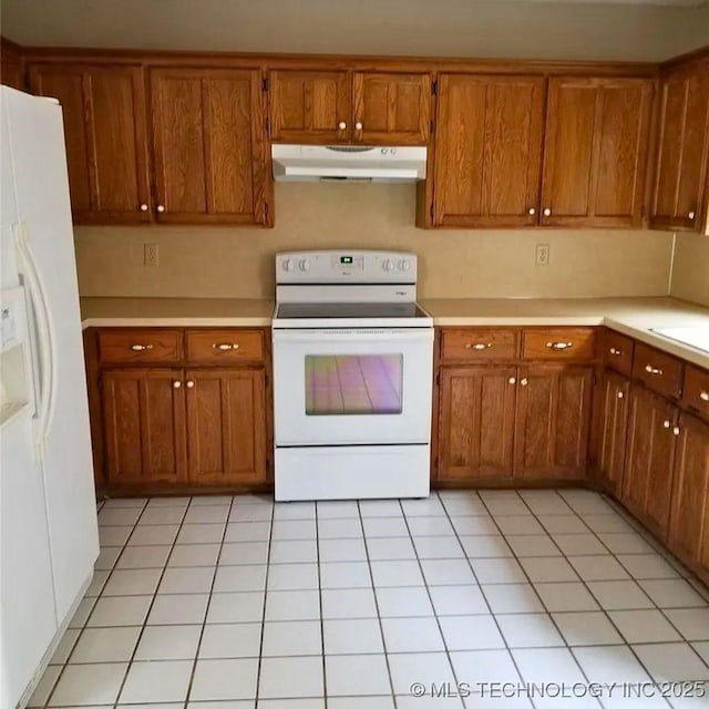 kitchen featuring light tile patterned flooring, sink, and white appliances