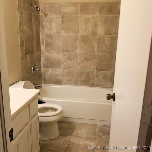 full bathroom featuring vanity, tiled shower / bath combo, and toilet