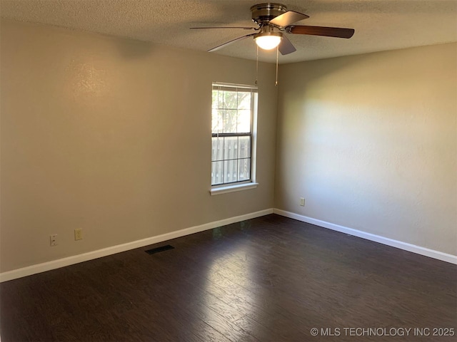 spare room with ceiling fan, dark wood-type flooring, and a textured ceiling