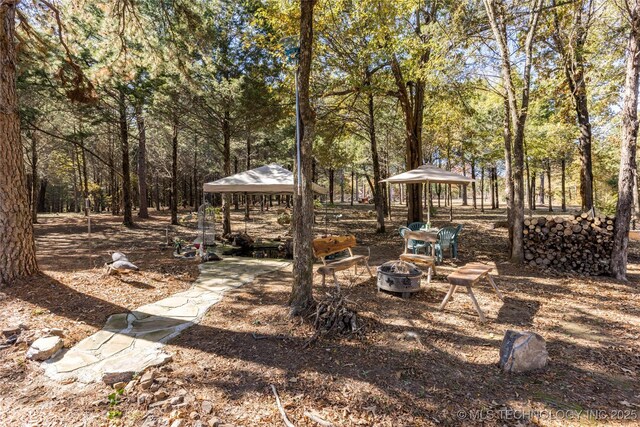 view of yard with a gazebo and an outdoor fire pit