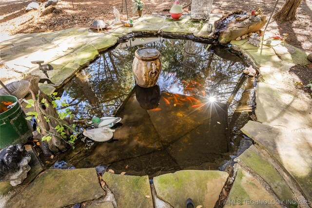 exterior details with a garden pond