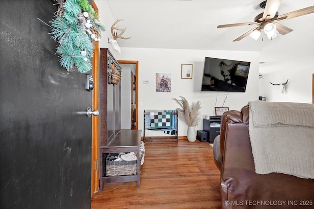 living room featuring hardwood / wood-style flooring and ceiling fan