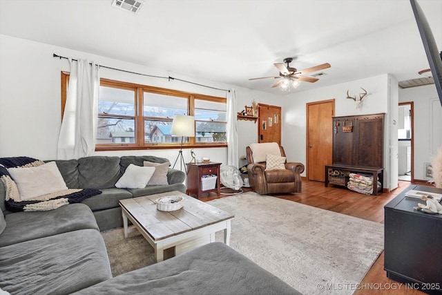 living room with ceiling fan and light hardwood / wood-style floors