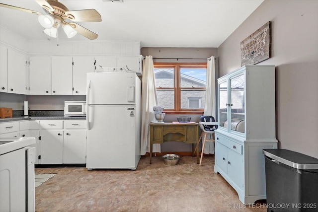 kitchen with ceiling fan, white appliances, and white cabinets