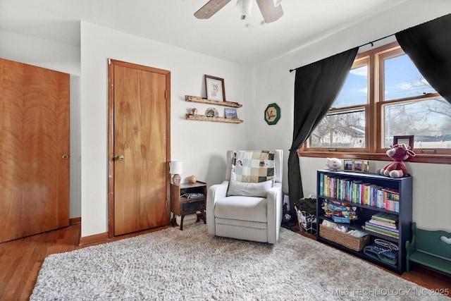 living area featuring ceiling fan and hardwood / wood-style floors