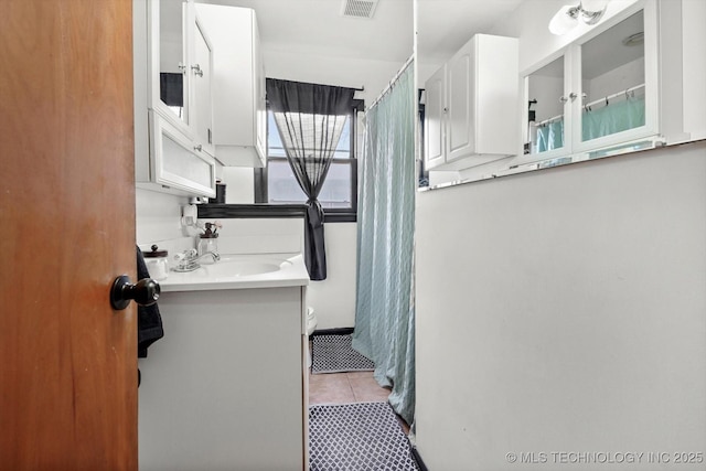 bathroom featuring vanity, tile patterned floors, and toilet