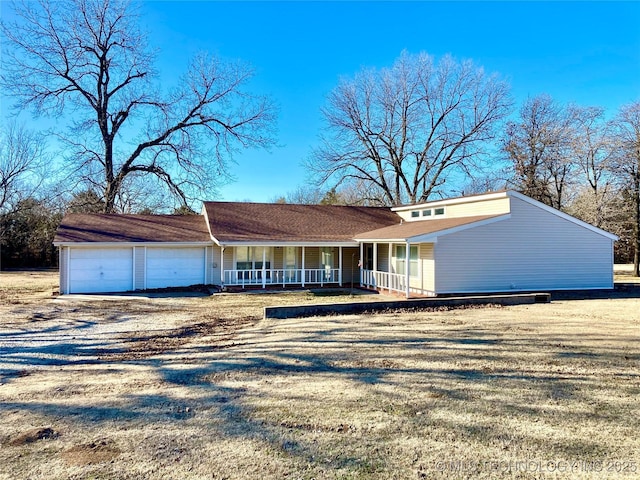 view of front of property featuring covered porch, driveway, and an attached garage