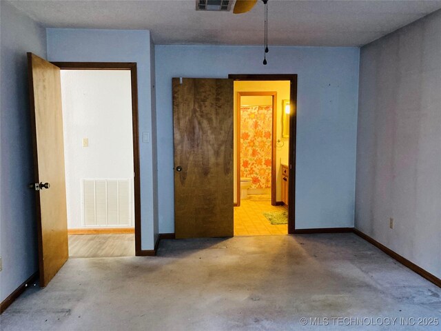 unfurnished room featuring concrete floors